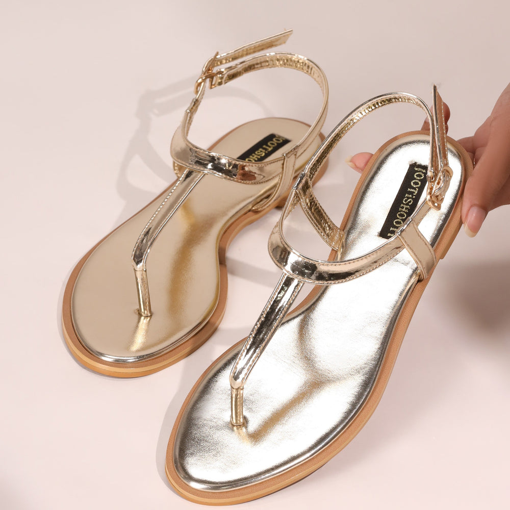 Gold sandals on a light background